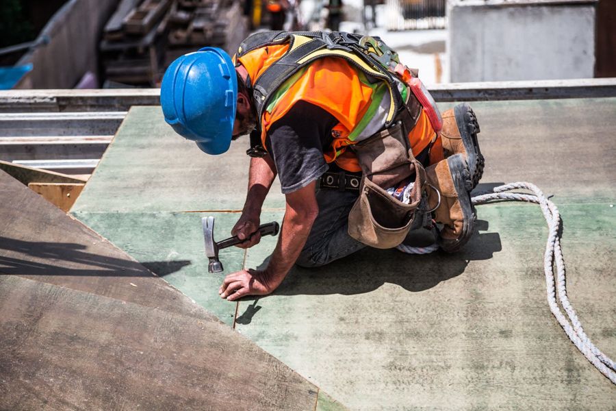 A roofer working on the roof deck